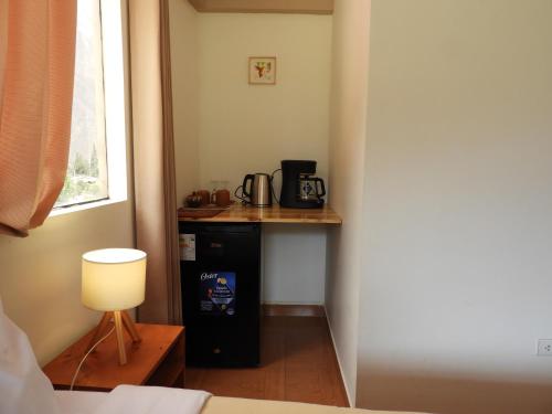 a room with a counter with a coffee maker on it at Ayllu B&B Ollantaytambo in Ollantaytambo