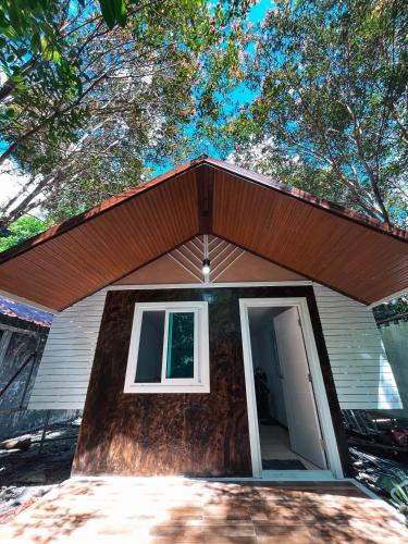 a small house with a roof with a door at Kama Siri Koh Kood in Ko Kood