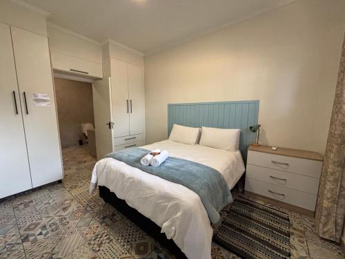 a bedroom with a bed with a teddy bear on it at 59 van Heerden in Mokopane