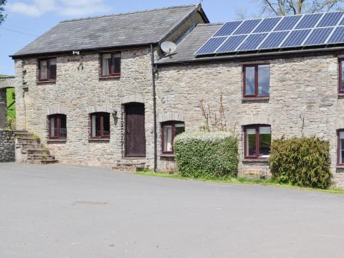 a house with solar panels on the roof at Woodland View-Uk11826 in Llandefaelogfâch