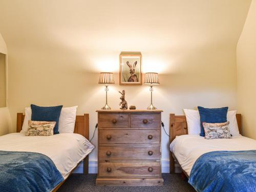 a bedroom with two twin beds and a dresser at Brynfields in Shirley