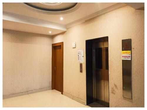 a hallway with a elevator and a door in a building at Manisha मनीषा Gaya in Gaya