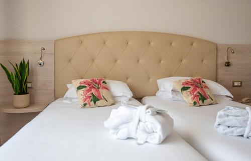 a bedroom with a bed with towels on it at Hotel Castello Artemide Congressi in Castel San Pietro Terme