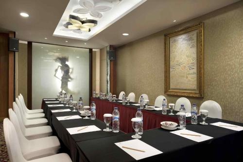 a conference room with long tables and white chairs at The Royal Surakarta Heritage - Handwritten Collection in Solo