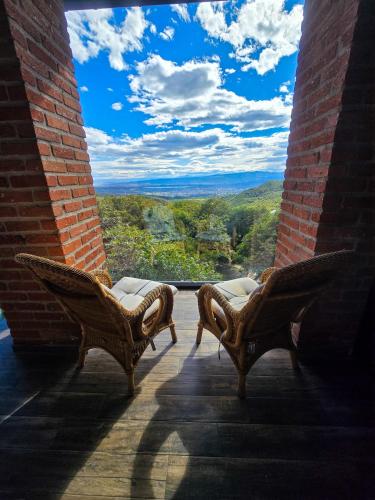 two chairs sitting on a porch with a view at Villa Vejini in Mamkoda