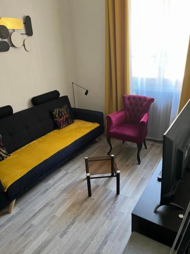 a living room with a couch and a chair at Chic & Elégance Lyon Centre in Lyon