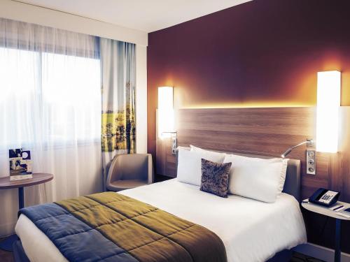 Ένα ή περισσότερα κρεβάτια σε δωμάτιο στο Hôtel Mercure Mâcon Bord de Saône