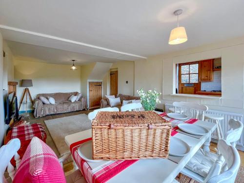 a living room with a table and chairs at Drovers Cottage in Tetbury