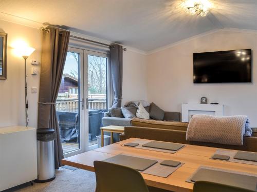 a living room with a couch and a table at Harwood Lodge - Uk45602 in Wilberfoss