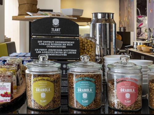 a display of food in jars on a counter at Novotel Brussels Centre Midi in Brussels