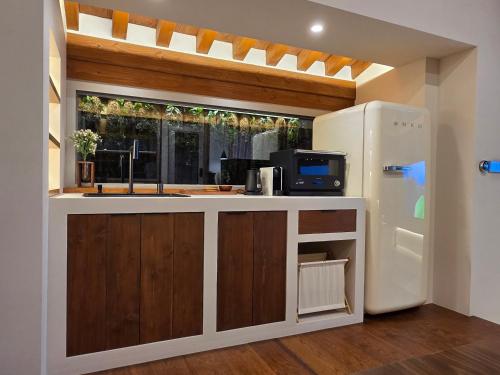 a kitchen with a sink and a refrigerator at Hyu Stay in Gyeongju
