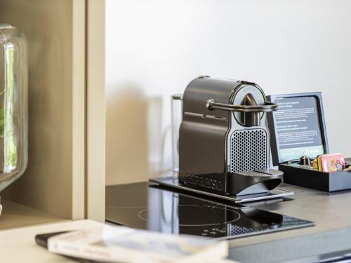 a radio sitting on top of a desk with a laptop at Aparthotel Adagio Rome Vatican in Rome