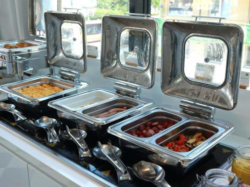 three trays of food sitting on a kitchen counter at Ibis Styles Wroclaw Centrum in Wrocław
