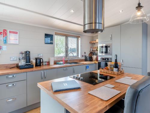 a kitchen with a wooden counter top with a laptop on it at Lakeside Lodge in Barholm