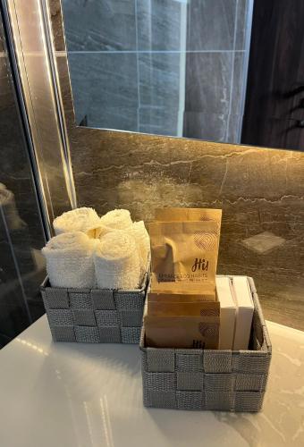 two baskets of towels sitting on a table at Oasis Penthouse Luxury Suite in Limassol
