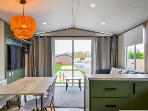 a kitchen and dining room with a table and a couch at Pine Meadows Retreat - Uk48919 in Wilberfoss