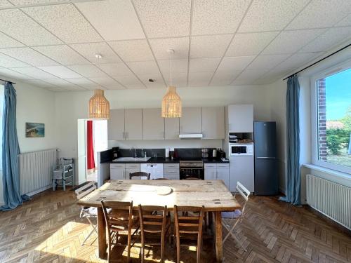 a kitchen with a wooden table and chairs at La Maison de Charme, 8-9p, idéale Amis et Familles in Sévigny