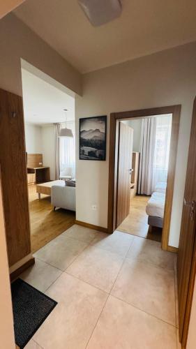 a living room with a room with a couch and a bed at Apartamenty Bistro12 in Sokoły
