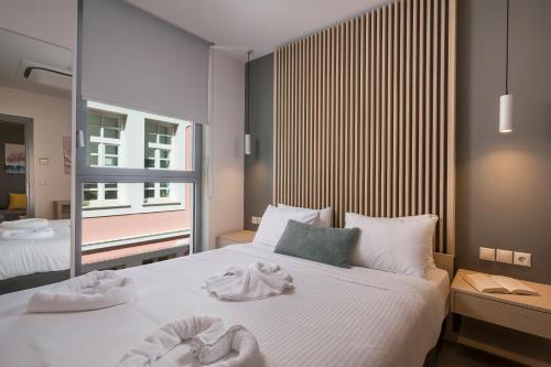 a bedroom with two people laying on a bed at Trianon Luxury Apartments & Suites in Chania Town