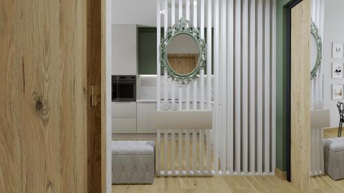 ein Wohnzimmer mit Spiegel und eine Küche in der Unterkunft Apartament Margaret in Oppeln