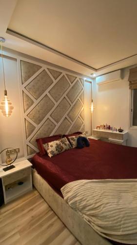 a bedroom with a large bed with a brick wall at Luxury capital apartment in Rabat