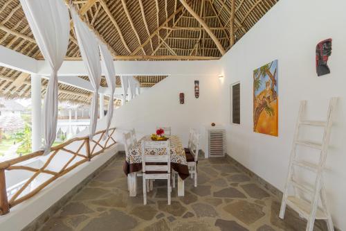 a dining room with a table and chairs at Leopard House in Watamu