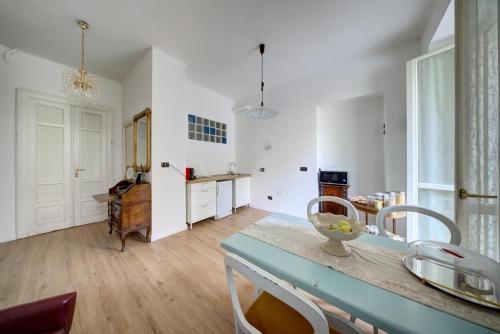 a kitchen with white walls and a table with chairs at Coli's House in Turin