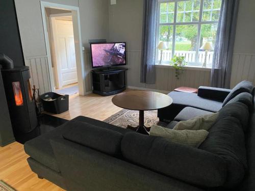 a living room with a couch and a tv at Tveitopark Apartments NO 2 in Øverland