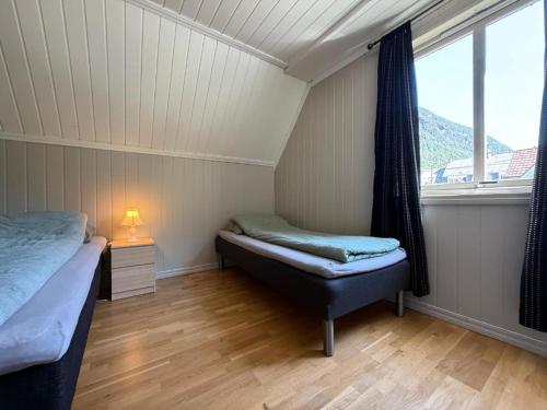 a small room with two beds and a window at Tveitopark Apartments B in Rjukan