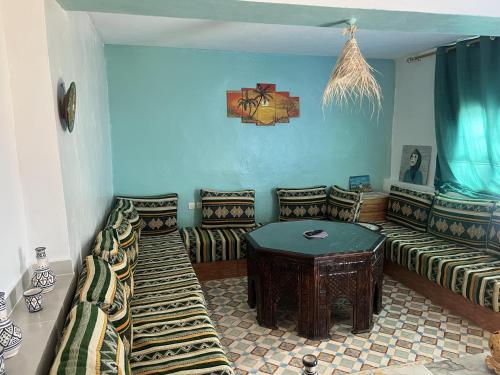 a living room with a couch and a table at Superbe Stay in Taghazout