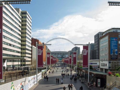 a city street with a ferris wheel in the background at Novotel London Wembley in London