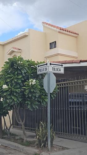 a street sign in front of a house at Private, centrally located, spacious and comfortable residence in Hermosillo
