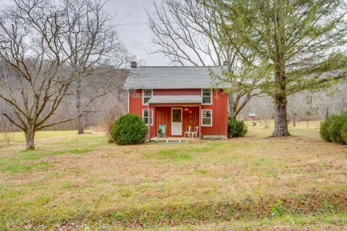 a red house in a field with trees at Chateau Merlot - Private Appalachian Cottage in Stanardsville