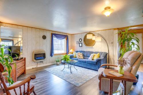 a living room with a blue couch and a table at Chateau Merlot - Private Appalachian Cottage in Stanardsville