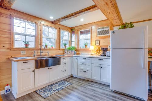 a kitchen with a white refrigerator and wooden walls at Chateau Merlot - Private Appalachian Cottage in Stanardsville