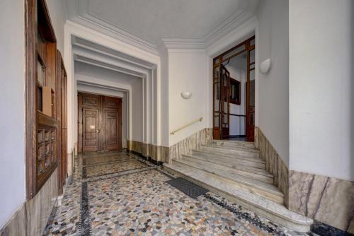 an empty hallway with stairs and a door at Coli's House in Turin
