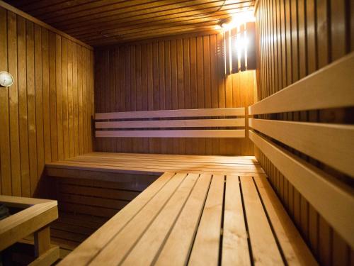 a wooden sauna with a bench in the middle at Mercure Riga Centre in Rīga