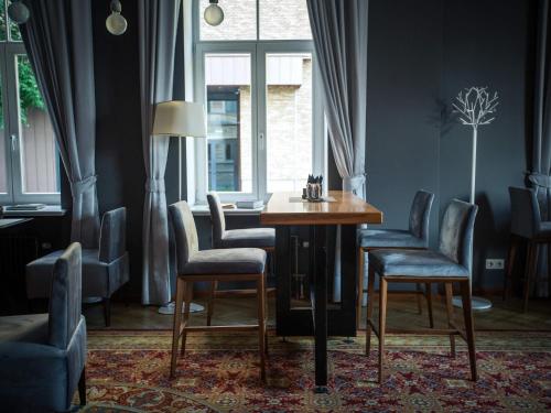 a dining room with a table and chairs and a window at Mercure Riga Centre in Rīga