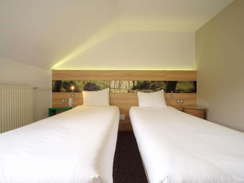 Ένα ή περισσότερα κρεβάτια σε δωμάτιο στο ibis Styles Sarrebourg