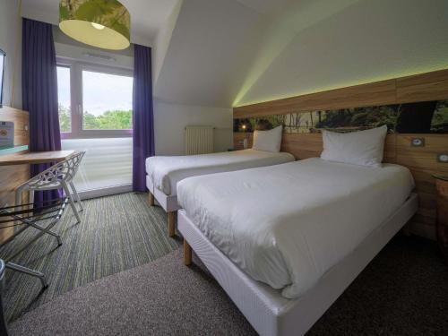 Ένα ή περισσότερα κρεβάτια σε δωμάτιο στο ibis Styles Sarrebourg