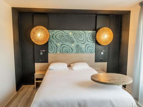 Ένα ή περισσότερα κρεβάτια σε δωμάτιο στο ibis Styles Marennes d'Oléron
