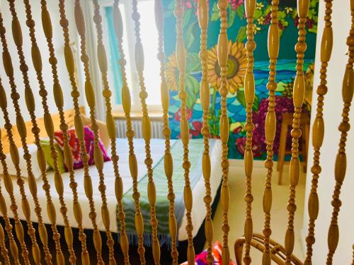 a bunch of beads hanging on a wall at Coco bay 2 in Saint-Benoît-des-Ondes