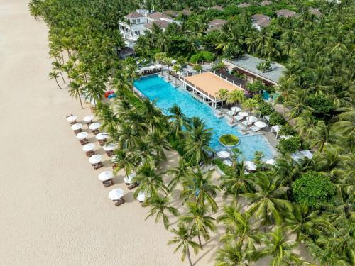 an aerial view of a resort with a pool and palm trees at Premier Village Danang Resort Managed By Accor in Da Nang