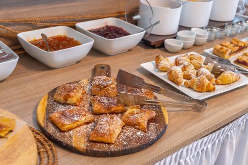 a table with a plate of pastries and other foods at Harmony Hotel in Kourouta