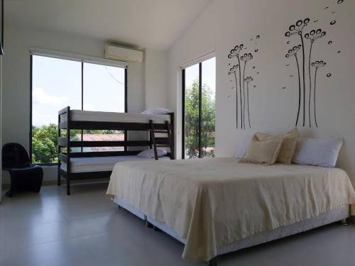 a bedroom with a bed and a large window at Exclusiva casa campestre in Ricaurte