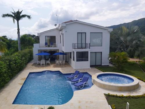 a villa with a swimming pool and a house at Exclusiva casa campestre in Ricaurte