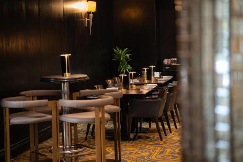 a row of tables and chairs in a restaurant at President Hotel in London