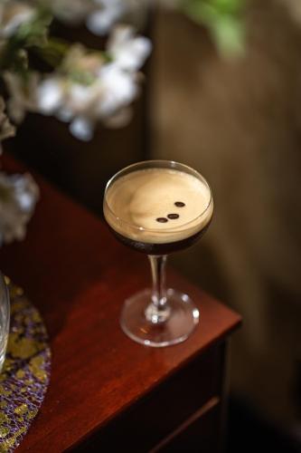 a wine glass sitting on a wooden table at President Hotel in London