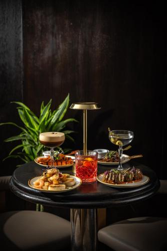 a table with three plates of food on it at President Hotel in London
