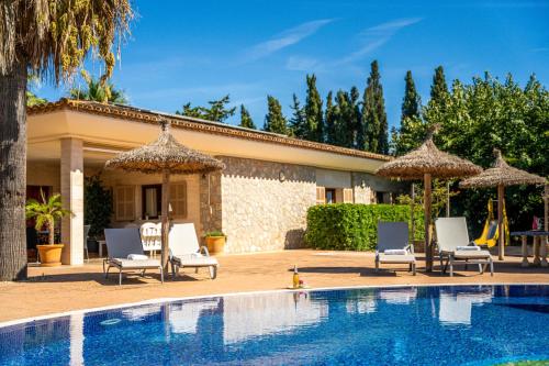 a pool with chairs and umbrellas next to a house at Ideal Property Mallorca - Son Manyo 223 in Sa Pobla